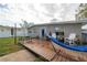 Cozy backyard with a wooden deck, hammock, outdoor seating, and a view of the home's exterior at 1773 Ezelle Ave, Largo, FL 33770