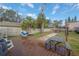 Backyard featuring a wooden deck, hammock, patio furniture, and a well-maintained lawn at 1773 Ezelle Ave, Largo, FL 33770