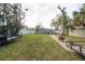 Large backyard with a fire pit, mature trees, a wooden deck, and ample parking space at 1773 Ezelle Ave, Largo, FL 33770
