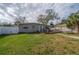 Backyard featuring a wooden deck, hammock, and lush green lawn at 1773 Ezelle Ave, Largo, FL 33770