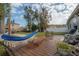 Backyard featuring a wood deck with a hammock and picnic table at 1773 Ezelle Ave, Largo, FL 33770