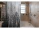 Shower featuring tiled walls, shower head and nature-themed shower curtain at 1773 Ezelle Ave, Largo, FL 33770