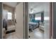 Cozy bedroom featuring a comfortable bed, ceiling fan, and a bathroom with tiled shower at 1773 Ezelle Ave, Largo, FL 33770