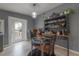 Cozy dining area with a glass table, open shelving, and a door leading to the backyard at 1773 Ezelle Ave, Largo, FL 33770