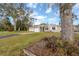 Inviting one-story home with lush front yard and a quaint, gray exterior at 1773 Ezelle Ave, Largo, FL 33770