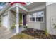 Charming home entrance with a purple front door, lush plants, and American flag on display at 1773 Ezelle Ave, Largo, FL 33770