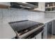 Modern kitchen range with stainless steel appliances and gray cabinets at 1773 Ezelle Ave, Largo, FL 33770