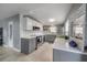 Stylish kitchen featuring gray and white cabinets, stainless steel appliances, and neutral backsplash at 1773 Ezelle Ave, Largo, FL 33770