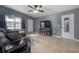 Cozy living room with tile flooring, ceiling fan, large TV, and comfortable seating arrangement at 1773 Ezelle Ave, Largo, FL 33770