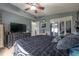 Comfortable main bedroom featuring a ceiling fan, dark furniture, and plenty of space at 1773 Ezelle Ave, Largo, FL 33770