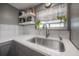 Kitchen sink area with gray cabinets, white countertops, and stainless steel appliances at 1773 Ezelle Ave, Largo, FL 33770