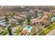 Scenic aerial view of a condo community featuring lush greenery, a pool, and covered parking areas at 1801 E Lake Rd # 11A, Palm Harbor, FL 34685