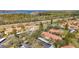 Expansive view of condo community showcasing red roofs, a pool, and surrounding lake at 1801 E Lake Rd # 11A, Palm Harbor, FL 34685