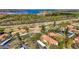 Overhead shot of condos near a lake, lush trees, and parking; serene community setting at 1801 E Lake Rd # 11A, Palm Harbor, FL 34685