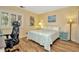 Cozy bedroom with wood flooring, white plantation shutters and calm light yellow colored walls at 1801 E Lake Rd # 11A, Palm Harbor, FL 34685