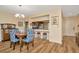 Dining area with stylish blue chairs and a view into the kitchen with a breakfast bar at 1801 E Lake Rd # 11A, Palm Harbor, FL 34685