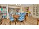 Charming dining room featuring hardwood floors and adjacent built in bookcase and a view into the kitchen at 1801 E Lake Rd # 11A, Palm Harbor, FL 34685