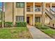 Close up of a charming condo showcasing a well maintained landscape and welcoming front door at 1801 E Lake Rd # 11A, Palm Harbor, FL 34685
