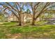 Two-story condo building with a red tile roof, balconies, set amidst lush green landscaping at 1801 E Lake Rd # 11A, Palm Harbor, FL 34685