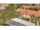 Charming condo building with a red tile roof, balconies, and convenient covered parking at 1801 E Lake Rd # 11A, Palm Harbor, FL 34685