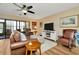 Comfortable living room with ceiling fan, leather furniture and sliding glass doors at 1801 E Lake Rd # 11A, Palm Harbor, FL 34685