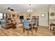 Open concept living and dining area with wood floors and comfortable seating at 1801 E Lake Rd # 11A, Palm Harbor, FL 34685