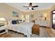 Comfortable main bedroom with wood floors, ceiling fan, and ample sunlight at 1801 E Lake Rd # 11A, Palm Harbor, FL 34685