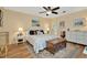 Comfortable main bedroom with wood floors, ceiling fan, and neutral decor at 1801 E Lake Rd # 11A, Palm Harbor, FL 34685