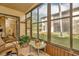 Enclosed patio with view of lawn, landscaping, and neighboring buildings at 1801 E Lake Rd # 11A, Palm Harbor, FL 34685