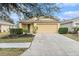 Inviting single-Gathering home featuring a well-manicured lawn and an attached two-car garage at 18155 Canal Pointe St, Tampa, FL 33647