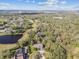 Aerial view of the property showcasing its extensive landscaping and proximity to the lake at 1902 Sweet Bay Ct, Plant City, FL 33566