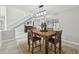 Open-concept dining area showcasing a rustic wooden table and elegant decor, adjacent to the foyer at 1902 Sweet Bay Ct, Plant City, FL 33566