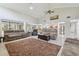 Spacious living room featuring vaulted ceilings, tile floors, and access to the kitchen at 1902 Sweet Bay Ct, Plant City, FL 33566