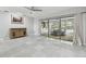 Open living room featuring tile floors, ceiling fan and sliding glass doors leading to the pool at 1902 Sweet Bay Ct, Plant City, FL 33566