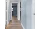 Hallway featuring light blue walls, light hardwood flooring, and a doorways leading to the rest of the home at 2 N Fernwood Ave # 33, Clearwater, FL 33765