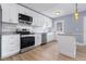 Bright kitchen with stainless steel appliances, white cabinets, and marbled countertops at 2 N Fernwood Ave # 33, Clearwater, FL 33765