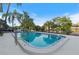 Outdoor pool featuring a metal railing, clean blue water, and several palm trees at 2 N Fernwood Ave # 33, Clearwater, FL 33765