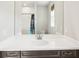 Bathroom featuring a large mirror over a vanity with a sink and storage drawers at 20237 Bandera Pl, Venice, FL 34293
