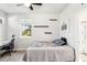 Bright bedroom offers a comfy bed, streamlined shelving, desk area, and a sunny window at 20237 Bandera Pl, Venice, FL 34293