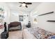 Bedroom featuring a bed, crib, desk, ceiling fan, and light-filled windows at 20237 Bandera Pl, Venice, FL 34293