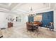 Dining room with a modern chandelier, an area rug, and accent wall paneling at 20237 Bandera Pl, Venice, FL 34293