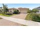 Inviting single-story home featuring a manicured lawn, a paver driveway, and a two-car garage at 20237 Bandera Pl, Venice, FL 34293