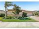 Well-kept house featuring verdant lawn, decorative landscaping, and a convenient two-car garage at 20237 Bandera Pl, Venice, FL 34293