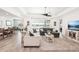 Bright living room featuring a sliding glass door, pool views, and tile floors at 20237 Bandera Pl, Venice, FL 34293
