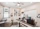 Bright home office with custom built-ins, a ceiling fan, and a comfortable sitting area at 20237 Bandera Pl, Venice, FL 34293