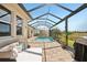 Charming screened-in patio area with comfortable seating and a lovely waterfront view at 20237 Bandera Pl, Venice, FL 34293