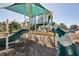 Community playground area with green and white slides, climbing structures, and protective shade covering at 20237 Bandera Pl, Venice, FL 34293