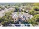 Aerial view of community center surrounded by mature trees and parking at 2171 Portofino Place # 27-2725, Palm Harbor, FL 34682