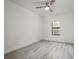 Well-lit bedroom with luxury vinyl plank flooring and a window with a view at 2171 Portofino Place # 27-2725, Palm Harbor, FL 34682
