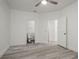This bedroom features light gray floors and two entryways with white trim at 2171 Portofino Place # 27-2725, Palm Harbor, FL 34682